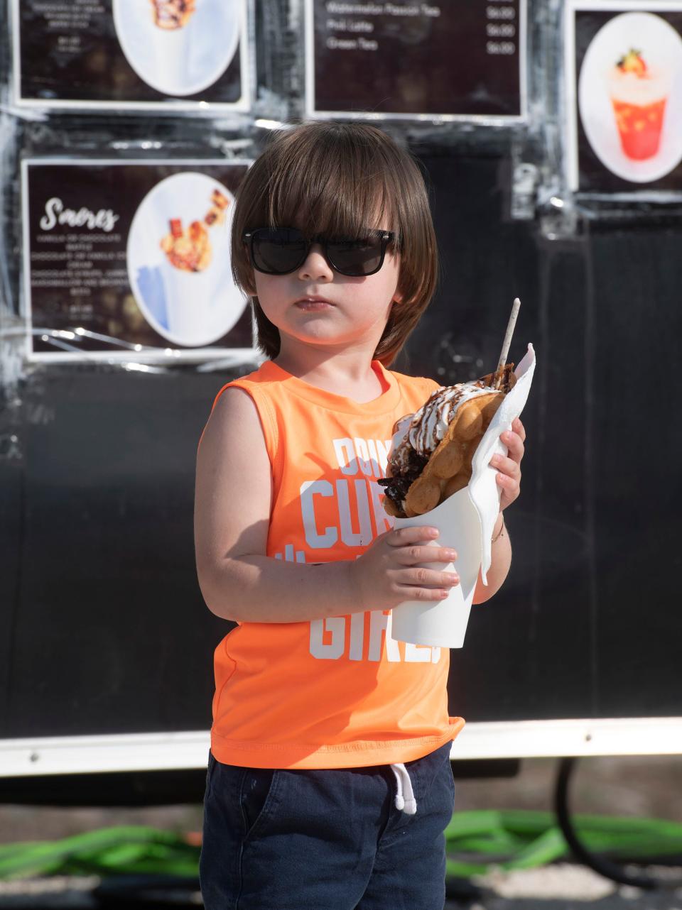 Jacob Bertan prepares to chow down on a tasty dessert from the Waffle Boutique food truck stationed at the new Truxtop Food Court in Gulf Breeze on Thursday, May 25, 2023. 