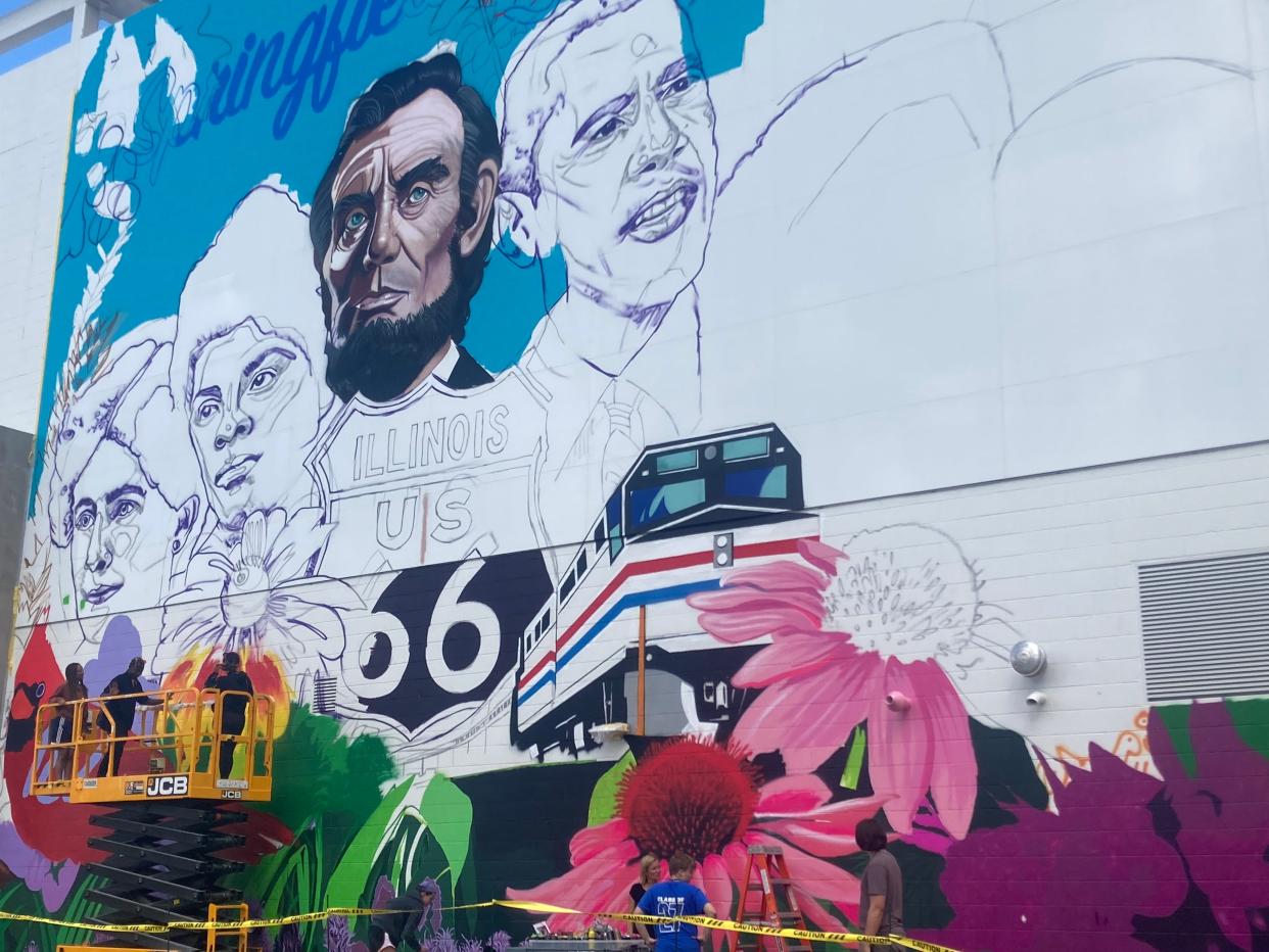 Work has begun on the installation of "Local Heroes" at the new Springfield-Sangamon County Transportation Hub along the 10th Street corridor. The 61-foot-wide, 47-foot-tall mural was designed by New York City artist Danielle Mastrion, who worked with several area students at a workshop on the site this past weekend.