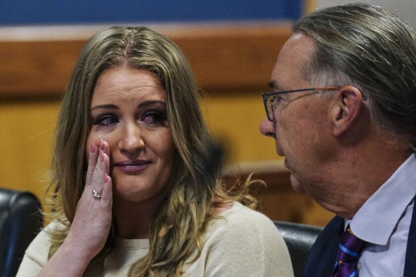 Jenna Ellis speaks with her attorney Franklin Houge after Ellis plead guilty to a felony count of aiding and abetting false statements and writings, inside Fulton Superior Court Judge Scott McAfee's Fulton County Courtroom, Tuesday, Oct. 24, 2023, in Atlanta. Ellis, an attorney and prominent conservative media figure, reached a deal with prosecutors Tuesday, Oct. 24, 2023, and pleaded guilty to a reduced charge over efforts to overturn Donald Trump's 2020 election loss in Georgia.(AP Photo/John Bazemore, Pool)