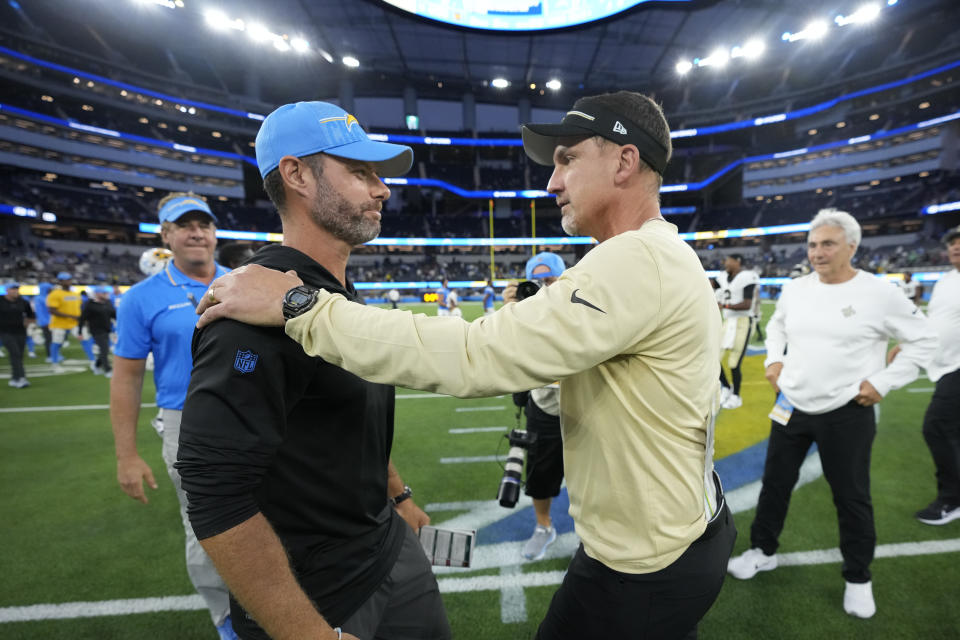 Los Angeles Chargers head coach Brandon Staley, left, greets New Orleans Saints head coach Dennis Allen after an NFL football game in Inglewood, Calif., Sunday, Aug. 20, 2023. The Saints won 22-17. (AP Photo/Marcio Jose Sanchez)