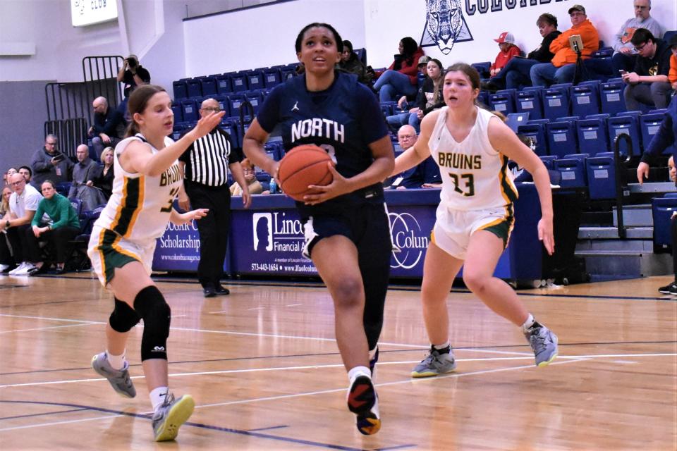 Blue Valley North's Aubrey Shaw drives between two Rock Bridge defenders on December 2, 2022, at the Columbia College’s Southwell Complex in Columbia, Mo.