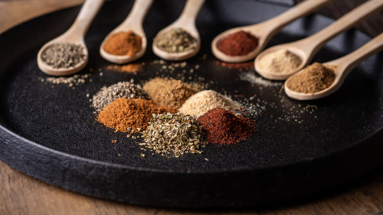 dried spices on black plate