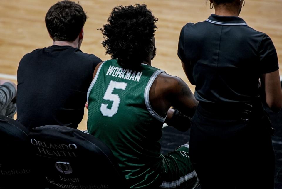 Jacksonville University senior forward Bryce Workman watches the Dolphins play against UCF from the bench after he injured his right hand three minutes into the game.