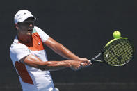 Miomir Kecmanovic of Serbia plays a backhand return to Lorenzo Sonego of Italy during their third round match at the Australian Open tennis championships in Melbourne, Australia, Friday, Jan. 21, 2022. (AP Photo/Tertius Pickard)