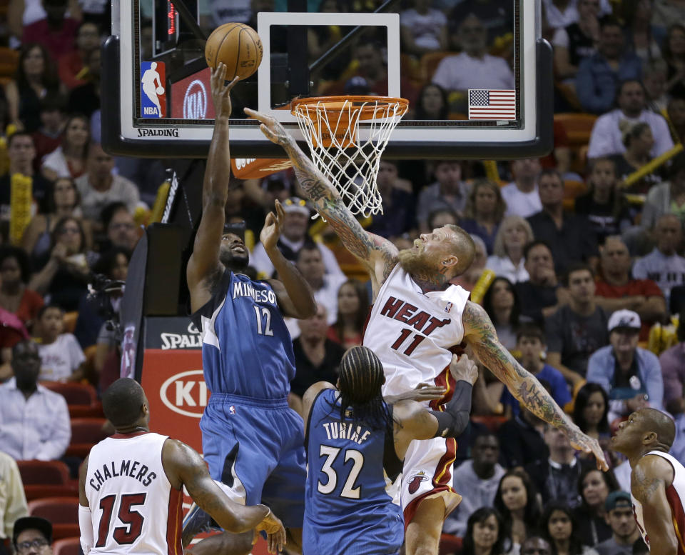 Minnesota Timberwolves forward Luc Richard Mbah a Moute (12) goes to the basket as Miami Heat forward Chris Andersen (11) defends during the first half of an NBA basketball game in Miami, Friday, April 4, 2014. (AP Photo/Alan Diaz)