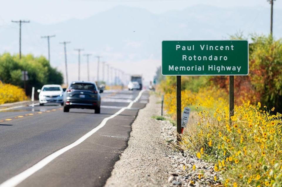 A sign identifying a section of Highway 140 near Gustine the Paul Vincent Rotondaro Memorial Highway in Merced County, Calif., on Monday, Sept. 18, 2023. Cal Fire Capt. Rotondaro was killed in a head-on traffic collision while on duty in Merced County on Oct. 2, 2019.