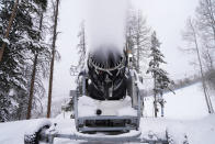 A machine blows snow at Vail Mountain Resort, Wednesday, Dec. 29, 2021, in Vail, Colo. Newer snowmaking technology is allowing ski areas to be more efficient with energy and water usage as climate change continues to threaten snowpack levels. (AP Photo/Brittany Peterson)