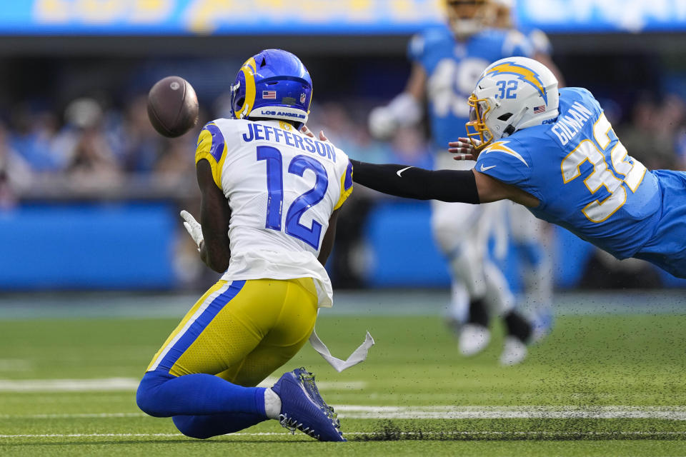 Los Angeles Rams wide receiver Van Jefferson (12) makes a catch against Los Angeles Chargers safety Alohi Gilman (32) during the first half of an NFL football game Sunday, Jan. 1, 2023, in Inglewood, Calif. (AP Photo/Mark J. Terrill)