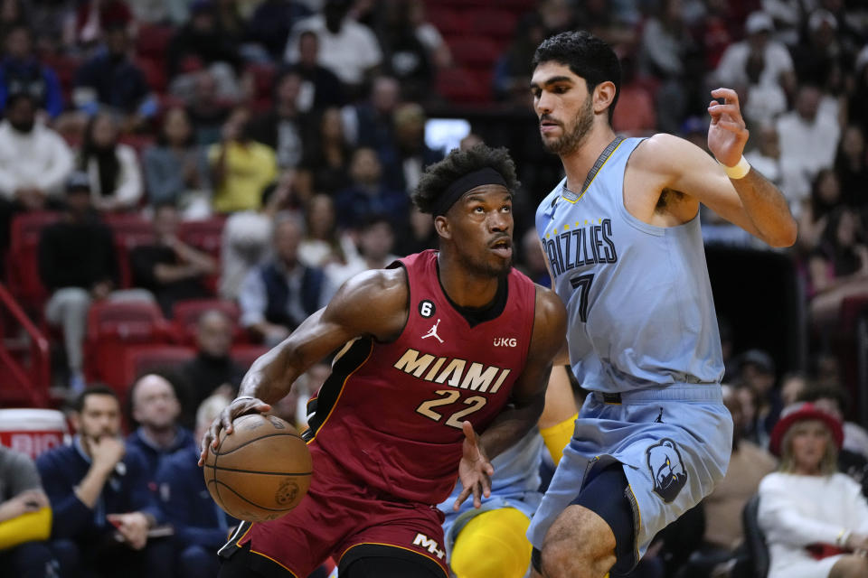 Miami Heat forward Jimmy Butler (22) drives past Memphis Grizzlies forward Santi Aldama (7) during the first half of an NBA basketball game Wednesday, March 15, 2023, in Miami. (AP Photo/Rebecca Blackwell)