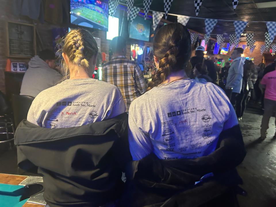 Two pub crawlers get their I-500 shirts signed at the first bar of the night at The Merchant's Bar on Thursday, Feb. 2, 2023.