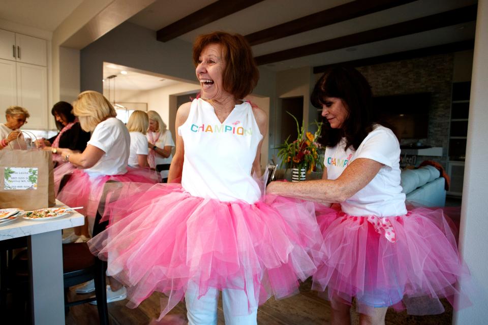 Karen Plesur and the Mixed Housewives of Del Webb, a group of women in the Del Webb neighborhood, craft pink tutus in Rancho Mirage, Calif., on Tuesday, October 4, 2022. The group fundraises for the Desert Cancer Foundation and plan to participate in the 16th Annual Paint El Paseo Pink breast cancer awareness walk. 