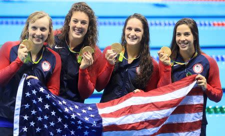 2016 Rio Olympics - Swimming - Victory Ceremony - Women's 4 x 200m Freestyle Relay Victory Ceremony - Olympic Aquatics Stadium - Rio de Janeiro, Brazil - 10/08/2016. Allison Schmitt (USA) of USA, Leah Smith (USA) of USA, Maya DiRado (USA) of USA and Katie Ledecky (USA) of USA pose with their gold medals and their national flag. REUTERS/Dominic Ebenbichler