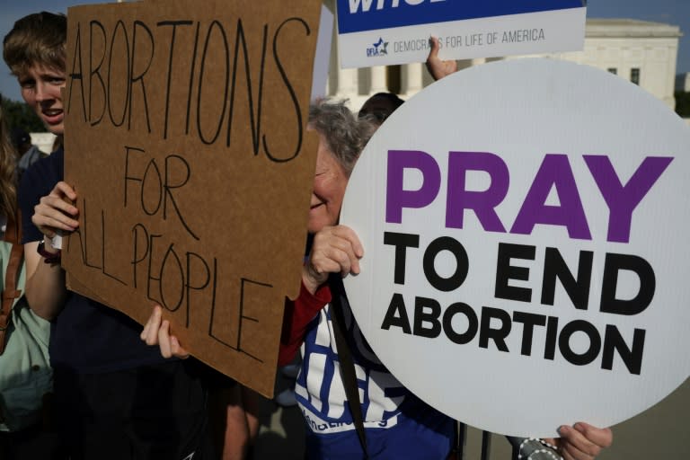 An anti-abortion activist and an abortion rights advocate during a rally outside the Supreme Court (ALEX WONG)