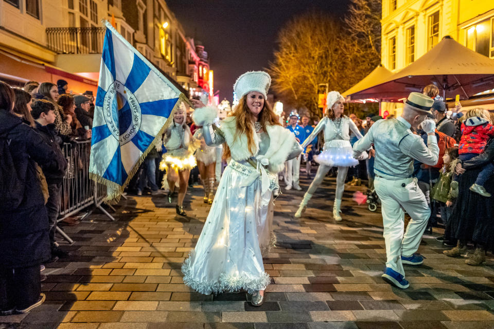 People gather wearing costumes for Brighton's annual 