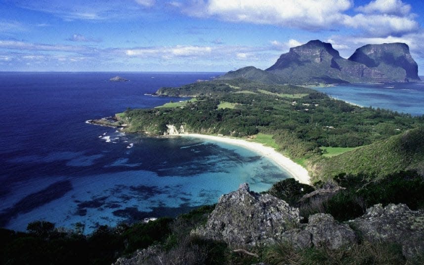 An undated photograph shows the World Heritage protected Lord Howe Island with Ned's Beach in foreground and Mount Lidgbird and Mount Gower behind - Credit: AFP