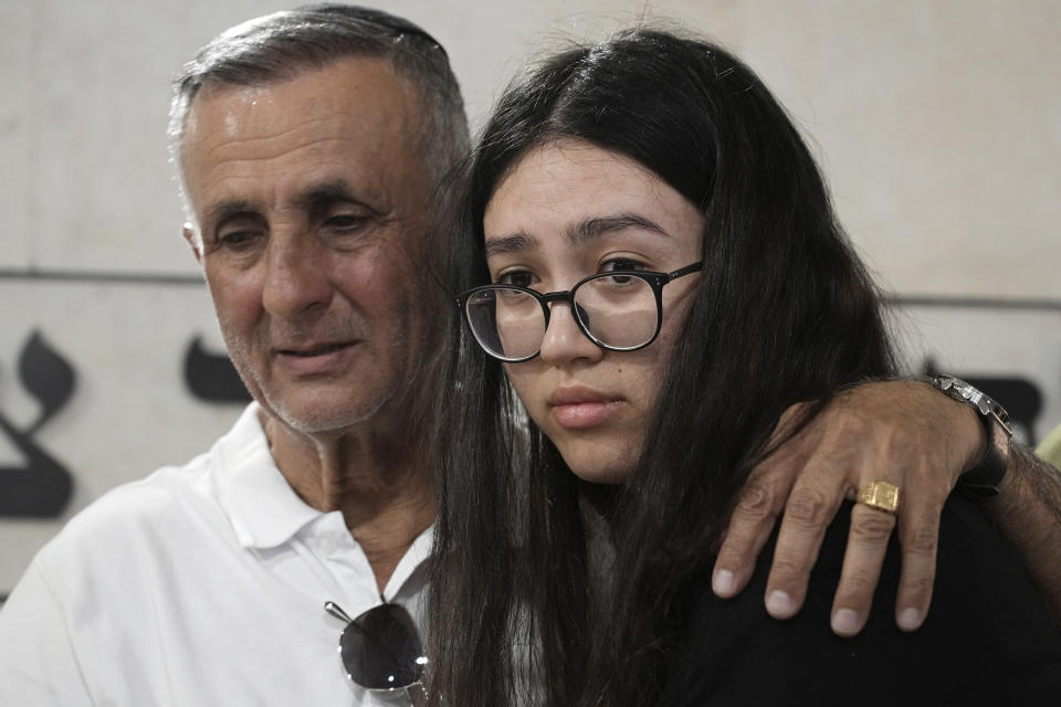 Freed Israeli hostage Noa Argamani, right, comforts her father Yakov, during the funeral for his wife and her mother Liora Argamani, in Beersheba, Israel, Tuesday, July 2, 2024. Liora Argamani, 61, who had stage four brain cancer, had pleaded for the release of her daughter, Noa, saying she wanted to see her only child before she died. (AP Photo/Tsafrir Abayov)