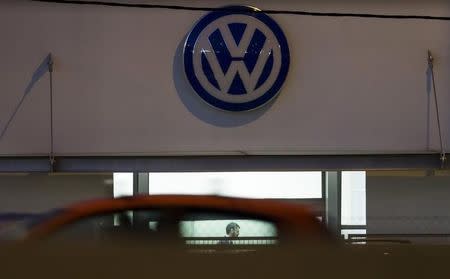 A vendor waits for customers at a Volkswagen dealership in Madrid, Spain, October 28, 2015. REUTERS/Sergio Perez