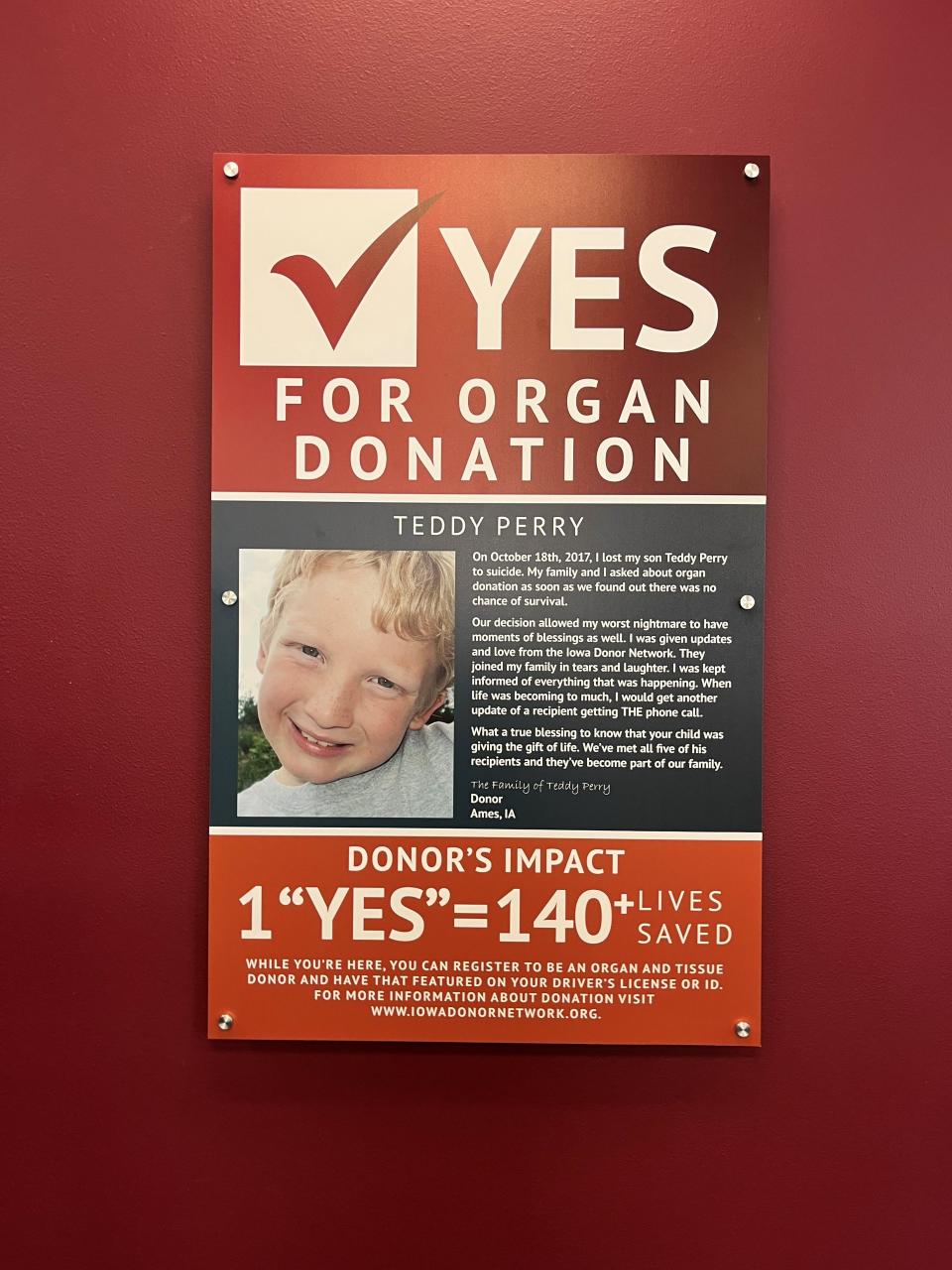 A plaque in honor of organ donor Teddy Perry is seen at the driver's license office in Ames after being unveiled June 29.