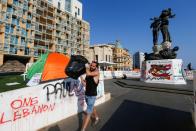 A demonstrator cleans a site of ongoing anti-government protests in Martyrs' Square, downtown Beirut