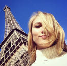 Repeat poser! In 2015, Karlie wrote, “Bonjour Paris,” on this pic of her posing beneath it again while rocking messy bangs. (Photo: Karlie Kloss via Instagram)