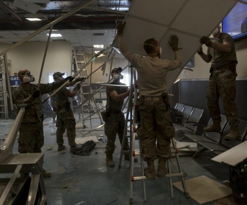 US military cleaning up debris after a Taliban-led attack at Bagram Airfield