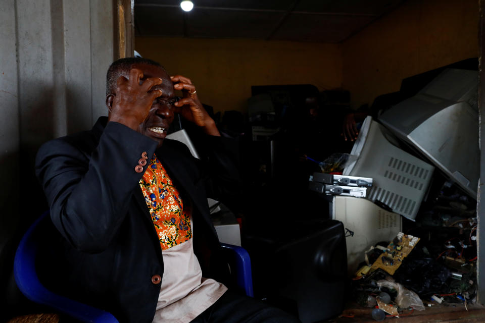 Kwaku Agyei, a pastor and resident of Obuasi, tells the story of slave trade to young workers in his neighborhood, in Obuasi, Ghana. "I can say our ancestors were the ones who developed America," he says. (Photo: Francis Kokoroko/Reuters)