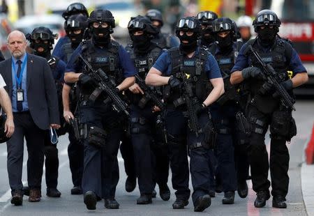 Armed police officers walk outside Borough Market after an attack left 6 people dead and dozens injured in London, Britain, June 4, 2017. REUTERS/Peter Nicholls