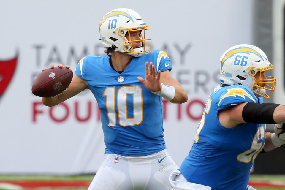 TAMPA, FL - OCTOBER 04: Justin Herbert (10) of the Chargers looks to throw a pass to his left side during the regular season game between the Los Angeles Chargers and the Tampa Bay Buccaneers on October 04, 2020 at Raymond James Stadium in Tampa, Florida. (Photo by Cliff Welch/Icon Sportswire via Getty Images)