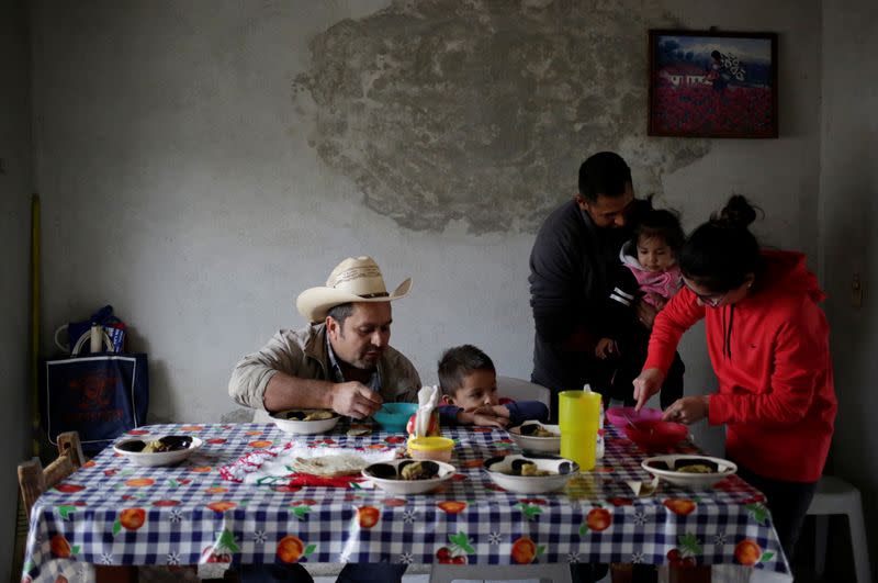 Jesus Mendoza 35, Mariela Ramirez 28 and their daughter Victoria 1, eat a meal with relatives in Jalpan de Serra