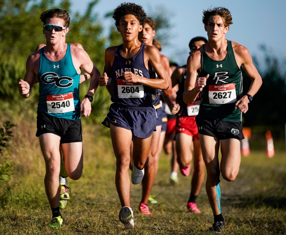 Gulf Coast runner William Montanye competes alongside 	Hector Toro of Naples and Hayden Clark of Palmetto Ridge during the Collier County Athletic Conference cross country championship at Palmetto Ridge High School in Naples on Wednesday, Oct. 25, 2023. Montanye would finish first followed by Clark and Toro.