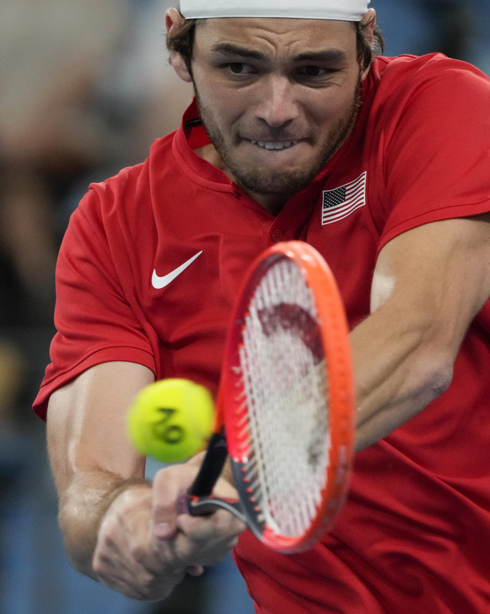 United States' Taylor Fritz plays a backhand return to Jiri Lehecka of the Czech Republic during their Group C match at the United Cup tennis event in Sydney, Australia, Thursday, Dec. 29, 2022. (AP Photo/Mark Baker)