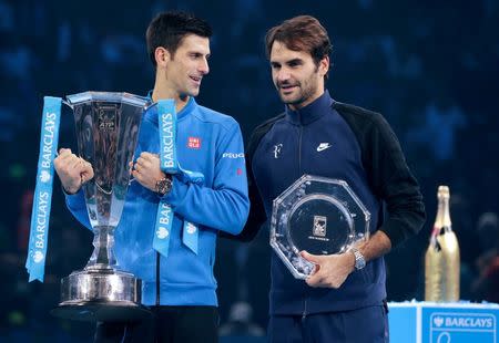 Tennis - Barclays ATP World Tour Finals - O2 Arena, London - 22/11/15 Men's Singles Final - Serbia's Novak Djokovic and Switzerland's Roger Federer pose with their trophies after their match Reuters / Suzanne Plunkett Livepic