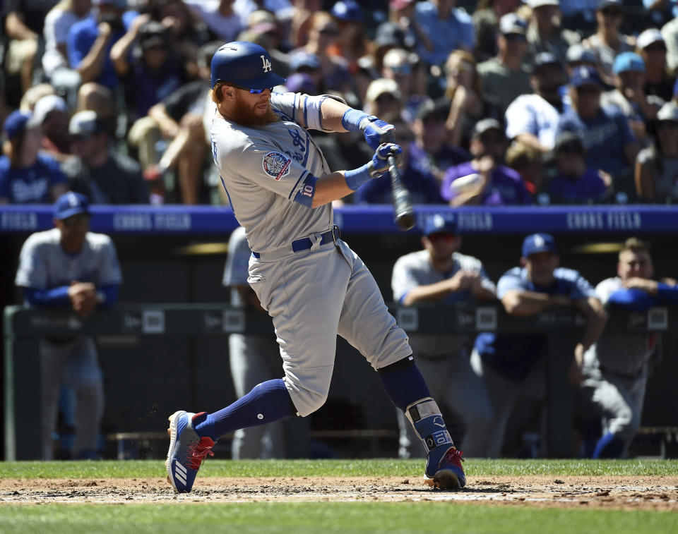 Los Angeles Dodgers’ Justin Turner gets a hit off Colorado Rockies starting pitcher Tyler Anderson to reach base on a fielding error by left fielder Matt Holliday in the second inning of a baseball game Sunday, Sept. 9, 2018, in Denver. (AP Photo/John Leyba)