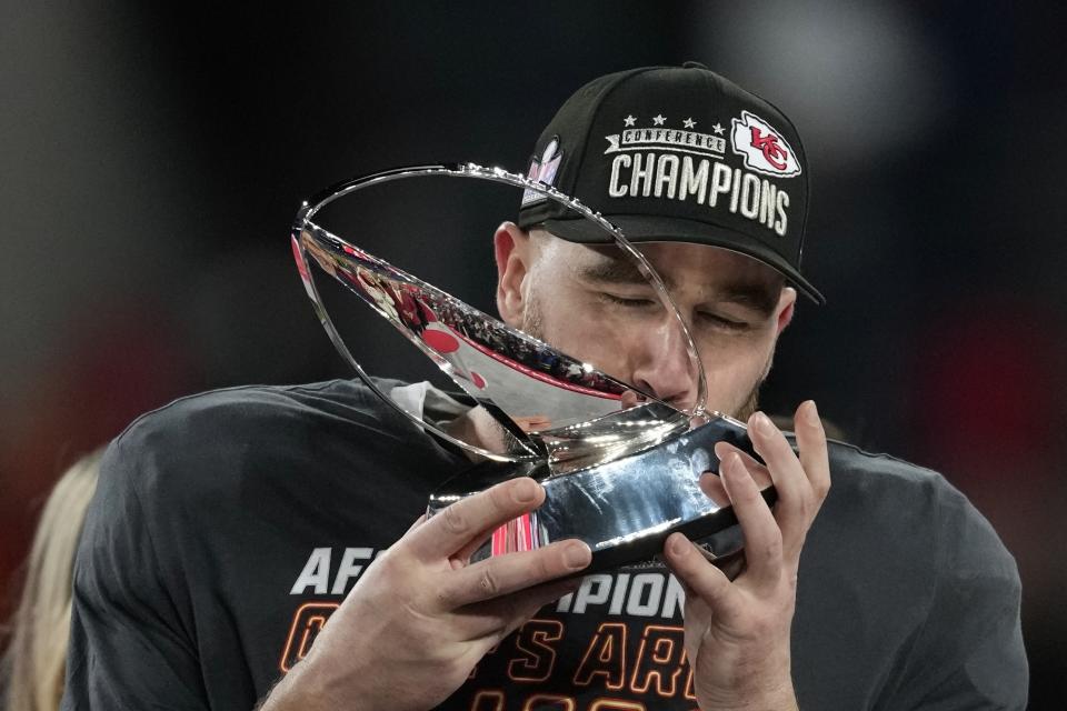 Kansas City Chiefs tight end Travis Kelce kisses the Lamar Hunt trophey after an AFC Championship NFL football game against the Baltimore Ravens, Sunday, Jan. 28, 2024, in Baltimore. The Chiefs won 17-10. (AP Photo/Nick Wass)