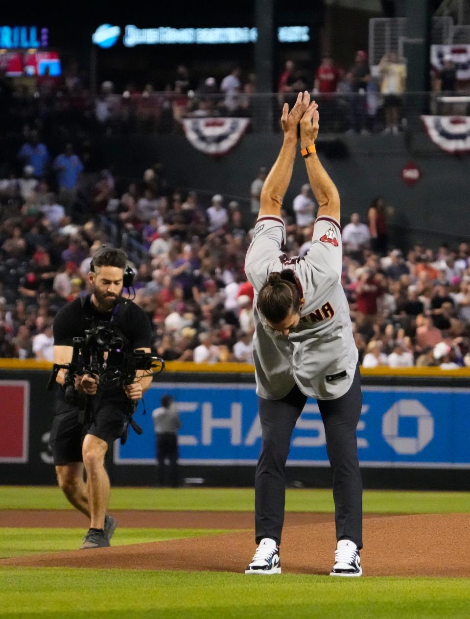Michael Phelps gestures to the crowd before throwing out the ceremonial first pitch before Game 5 of the NLCS of the 2023 MLB playoffs between the Arizona Diamondbacks and the Philadelphia Phillies on Oct. 21, 2023, at Chase Field in Phoenix, AZ. The Phillies beat the Diamondbacks 6-1, giving Philadelphia the overall lead of 3-2 in the NLCS playoffs.