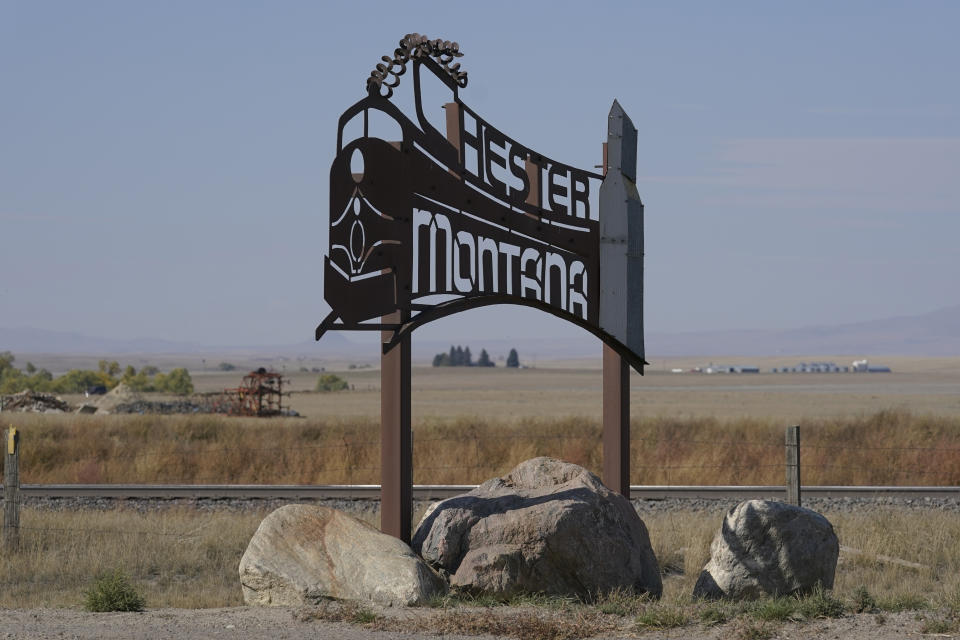 An image of a train is featured on a sign for the town of Chester, Mont., Monday, Sept. 27, 2021, near the scene where an Amtrak train derailed Saturday, killing three people and injuring others. Trains are a crucial aspect of the local agricultural economy in this part of the state, and officials said that the tracks where the derailment took place will be repaired as quickly as possible. (AP Photo/Ted S. Warren)