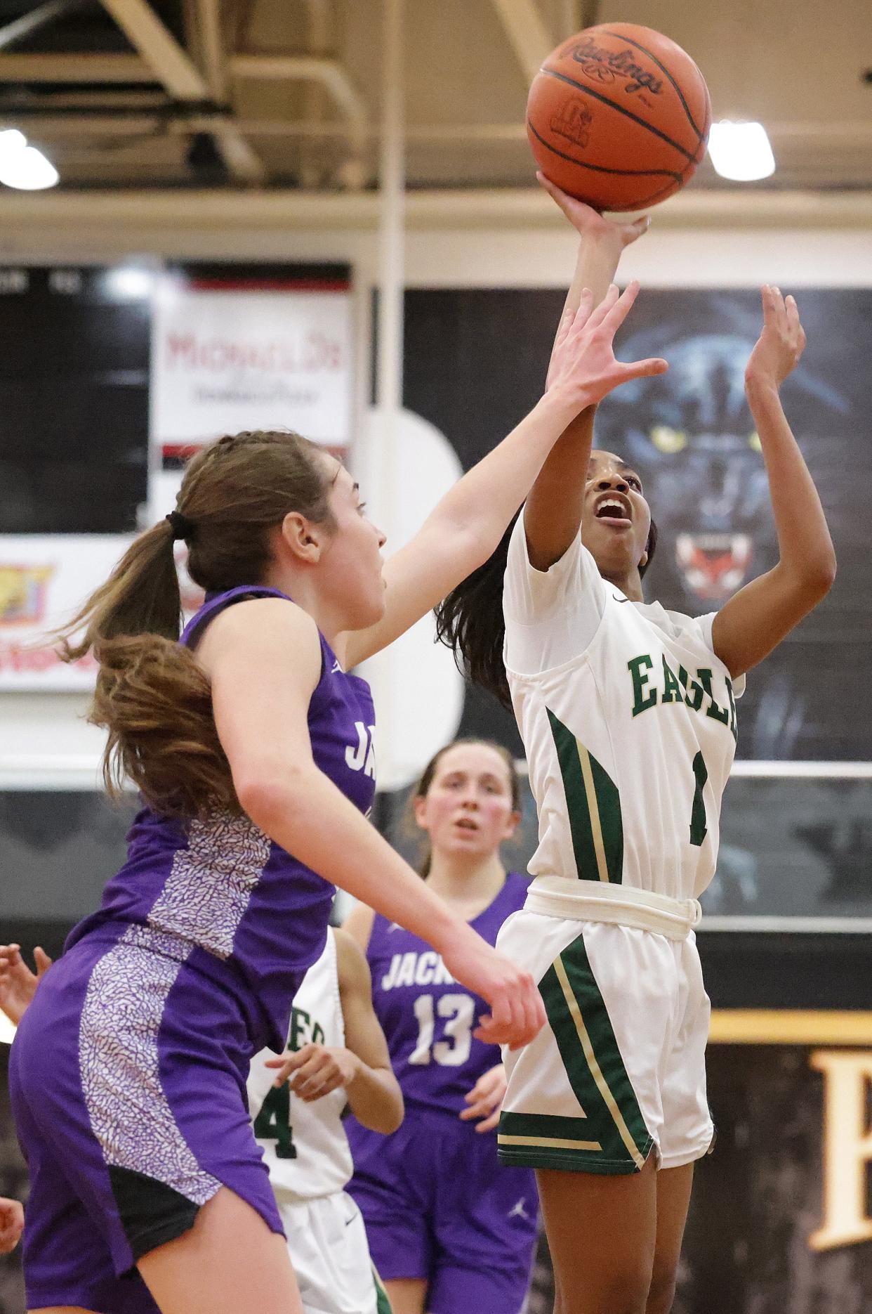 GlenOak's Chandler Vaughn shoots over Jackson's Megan Campbell in the first half of the Division I district championship at Perry High School, Friday, Feb. 25, 2022.