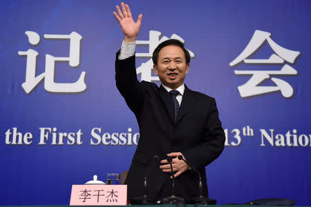 Chinese Environment Minister Li Ganjie attends a news conference on the sidelines of the National People's Congress (NPC) at the Great Hall of the People in Beijing, China March 17, 2018. REUTERS/Stringer