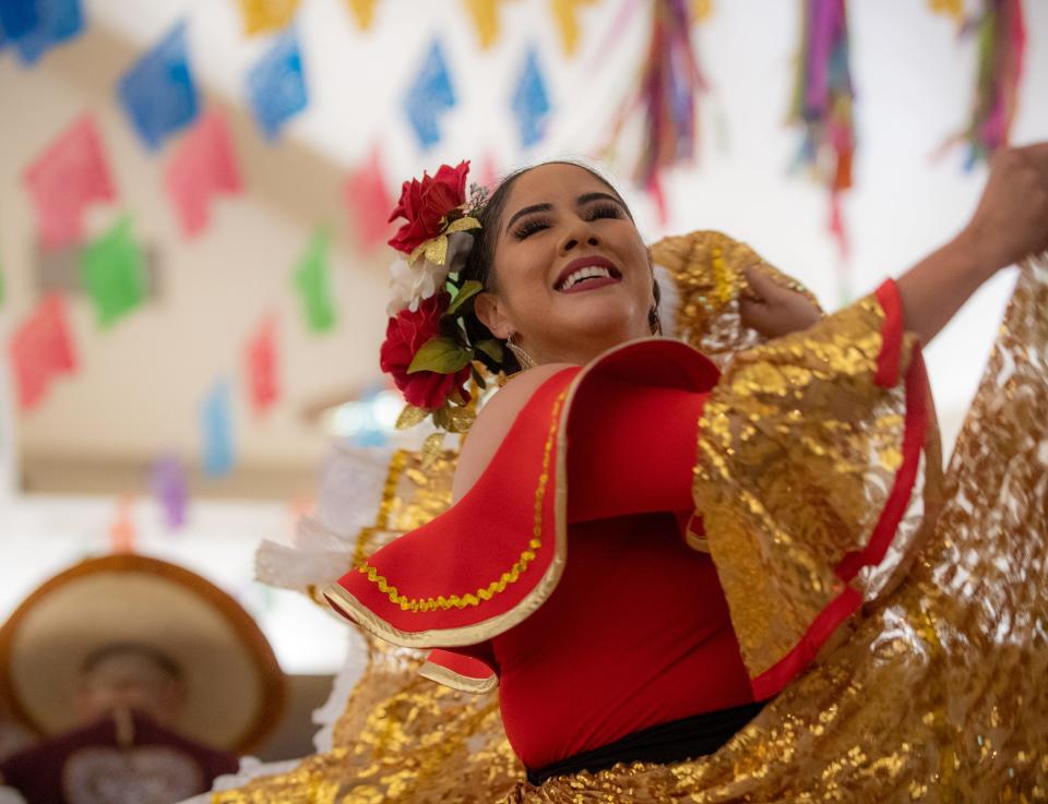 File photo - Folklorico dancer swings her golden dress around during the annual veneration of the Virgen de Guadalupe's novena at the St. Mary of the Nativity Church on Dec. 03, 2019.