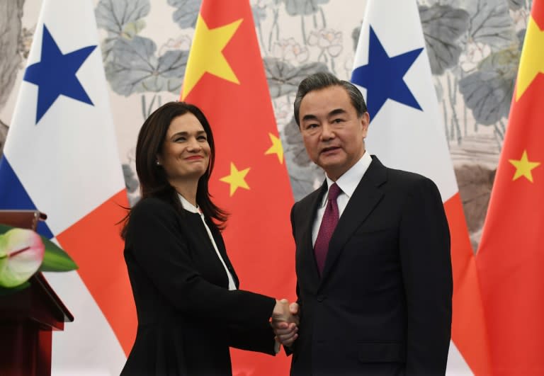 Panama's Vice President and Foreign Minister Isabel Saint Malo shakes hands with Chinese Foreign Minister Wang Yi after the two signed a joint communique agreeing to establish diplomatic relations, in Beijing, on June 13, 2017