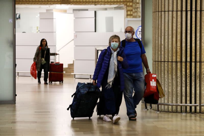 FILE PHOTO: Passengers walk at the arrival area of a terminal at the Ben Gurion airport in Lod