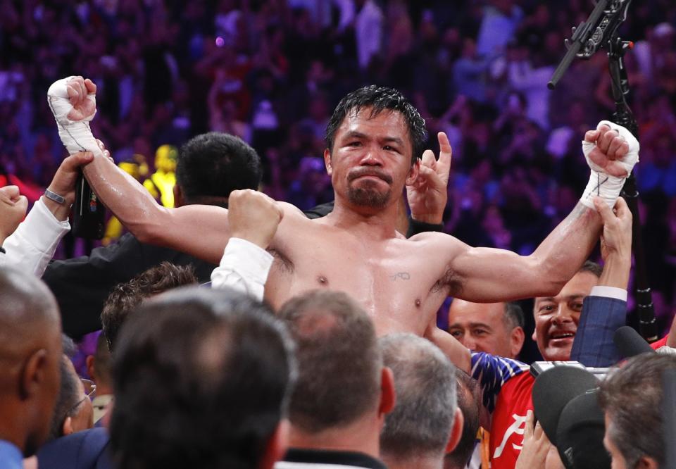 Manny Pacquiao raises his arms in victory.