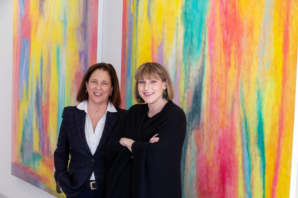 Caitlin Kelly-McKenna, right, owner and founder, and Megan Hay Guglielmo, left, gallery senior adviser, appear in front of art pieces at Kelly-McKenna Gallery in Spring Lake, NJ Monday, February 13, 2023.