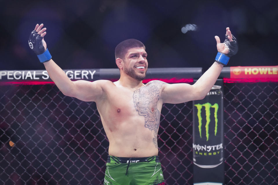 Jun 24, 2023; Jacksonville, Florida, USA; Chepe Mariscal (blue gloves) celebrates after he Trevor Peek (red gloves) in a lightweight bout during UFC Fight Night at VyStar Veterans Memorial Arena. Mandatory Credit: David Yeazell-USA TODAY Sports