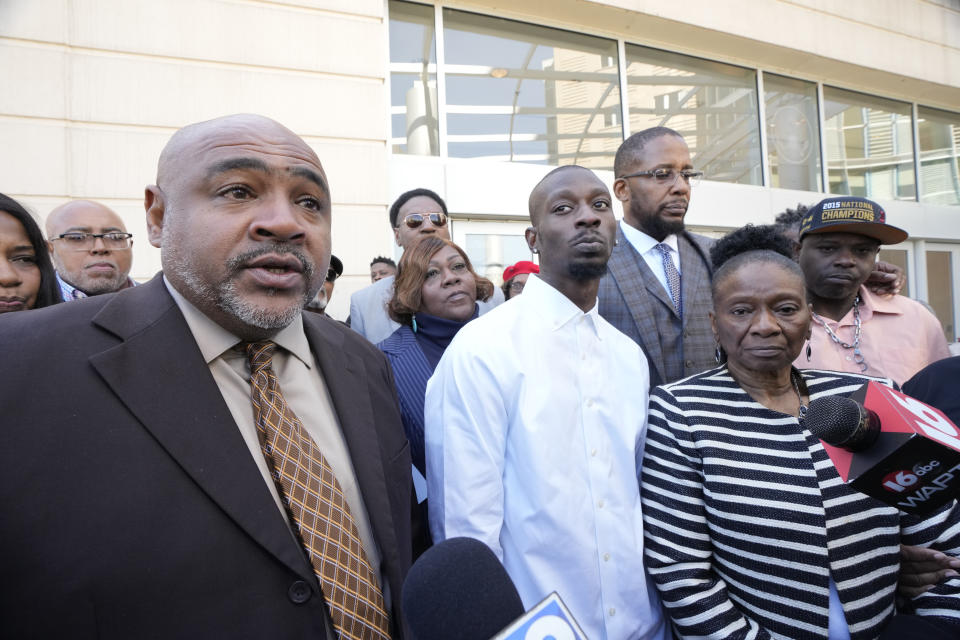 Co-counsel Trent Walker, left, speaks on the 20 years in prison former Mississippi Rankin County Sheriff's Deputy Hunter Elward, unseen, received in federal court for his part in torturing Michael Corey Jenkins, center, and Eddie Terrell Parker, far right, Tuesday, March 19, 2024, in Jackson, Miss. Elward is one of six former Mississippi Rankin County law enforcement officers who committed numerous acts of racially motivated, violent torture on Jenkins and Parker. Sentencing started Tuesday since the men had earlier pleaded guilty to a number of charges. (AP Photo/Rogelio V. Solis)