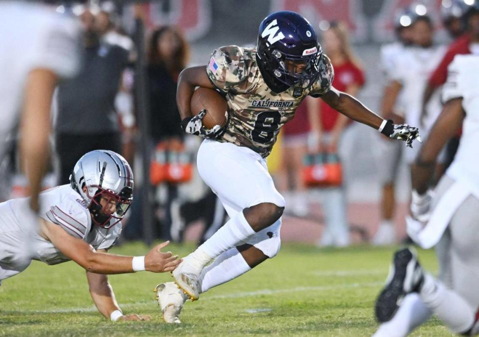 Washington Union’s Decurtis Stroud, right, espcaes the grip of Torres’ Joseph Bass, left, Friday, Sept. 1, 2023 in Easton.