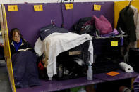 <p>A woman reads a book in the benching area on Day One of competition at the Westminster Kennel Club 142nd Annual Dog Show in New York, Feb.12, 2018. (Photo: Shannon Stapleton/Reuters) </p>