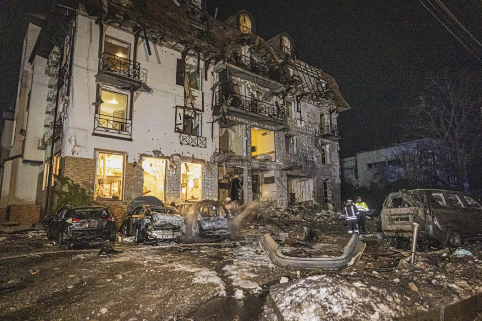 In this photo provided by the Ukrainian Emergency Service, firefighters examine the site of Russia's missile attack that hit a hotel in Kharkiv, Ukraine, late Wednesday, Jan. 10, 2024. (Ukrainian Emergency Service via AP)