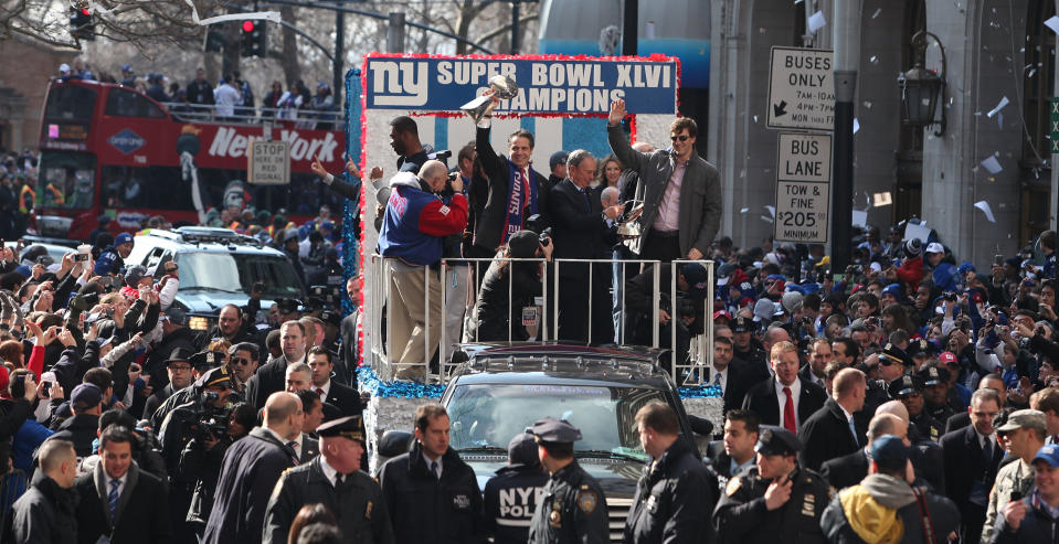 NEW YORK, NY - FEBRUARY 07:  (L-R) Justin Tuck #91 of the New York Giants, New York Gov. Andrew Cuomo, New York City Mayor Michael Bloomberg and quarterback Eli Manning #10 of the New York Giants stand on a float during the Giants' Victory Parade on February 7, 2012 in New York City. The Giants defeated the New England Patriots 21-17 in Super Bowl XLVI.  (Photo by Andrew Burton/Getty Images)