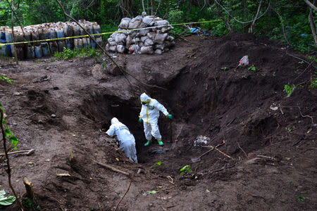 Forensic technicians of the Mexican Navy are seen at a clandestine drug processing laboratory where they seized 50 tons of methamphetamine discovered during an operation in the town of Alcoyonqui, on the outskirts of Culiacan, Mexico, in this handout photo released to Reuters by Mexico's Navy on August 17, 2018. SEMAR Mexico's Navy/Handout via REUTERS